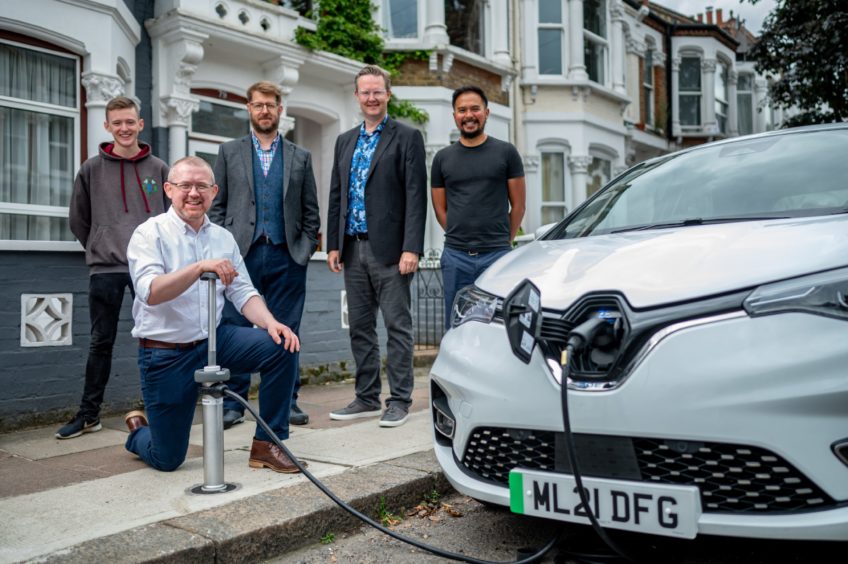 Trojan Energy CEO Ian Mackenzie and team members next to a charging point.