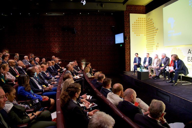 People sitting in an auditorium looking at people on stage