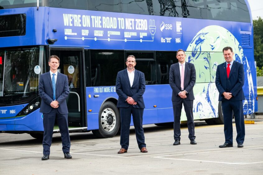 Left to right, David Brown, Chief Executive, Go-Ahead Group, Nathan Sanders, Managing Director of SSE Distributed Energy, Paul Davies, President and Managing Director of Alexander Dennis (ADL) and Frank Thorpe Managing Director of BYD UK standing in front of the Road to Renewables Bus which will travel from London to Glasgow arriving ahead of COP26. Northumberland Park Bus Depot, London. Supplied by SSE Date; 18/10/2021