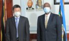 Two men in suits with masks on