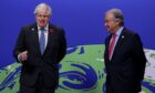 Boris Johnson, U.K. prime minister, left, and Antonio Guterres, secretary general of the United Nations, wait to greet attendees at the COP26 climate talks in Glasgow, U.K., on Monday, Nov. 1, 2021. The United Nations has convened world leaders many times before to discuss climate change, U.S. climate envoy, John Kerry, says COP26 will be the last chance for the world to avoid climate disaster. Photographer: Emily Macinnes/Bloomberg