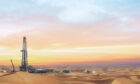 Drilling rig on the left hand side amid sand dunes