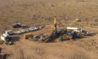 Aerial shot of drill site in dusty surroundings