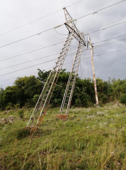 A pylon coming out of the earth, leaning against a second set of wires