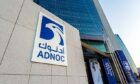 Blue Adnoc logo on a building outside an office