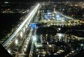 Highway from above at night lit up as cars drive along