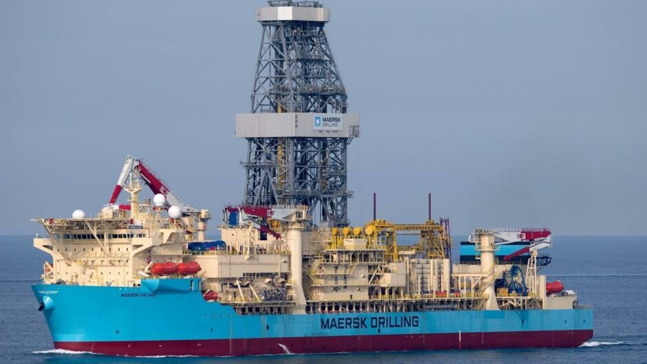 Blue hulled drillship in water, with Maersk Drilling on the side