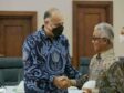 BP's Indonesia representative shakes hands with SKKMigas chairman Dwi Soetjipto after signing PSCs