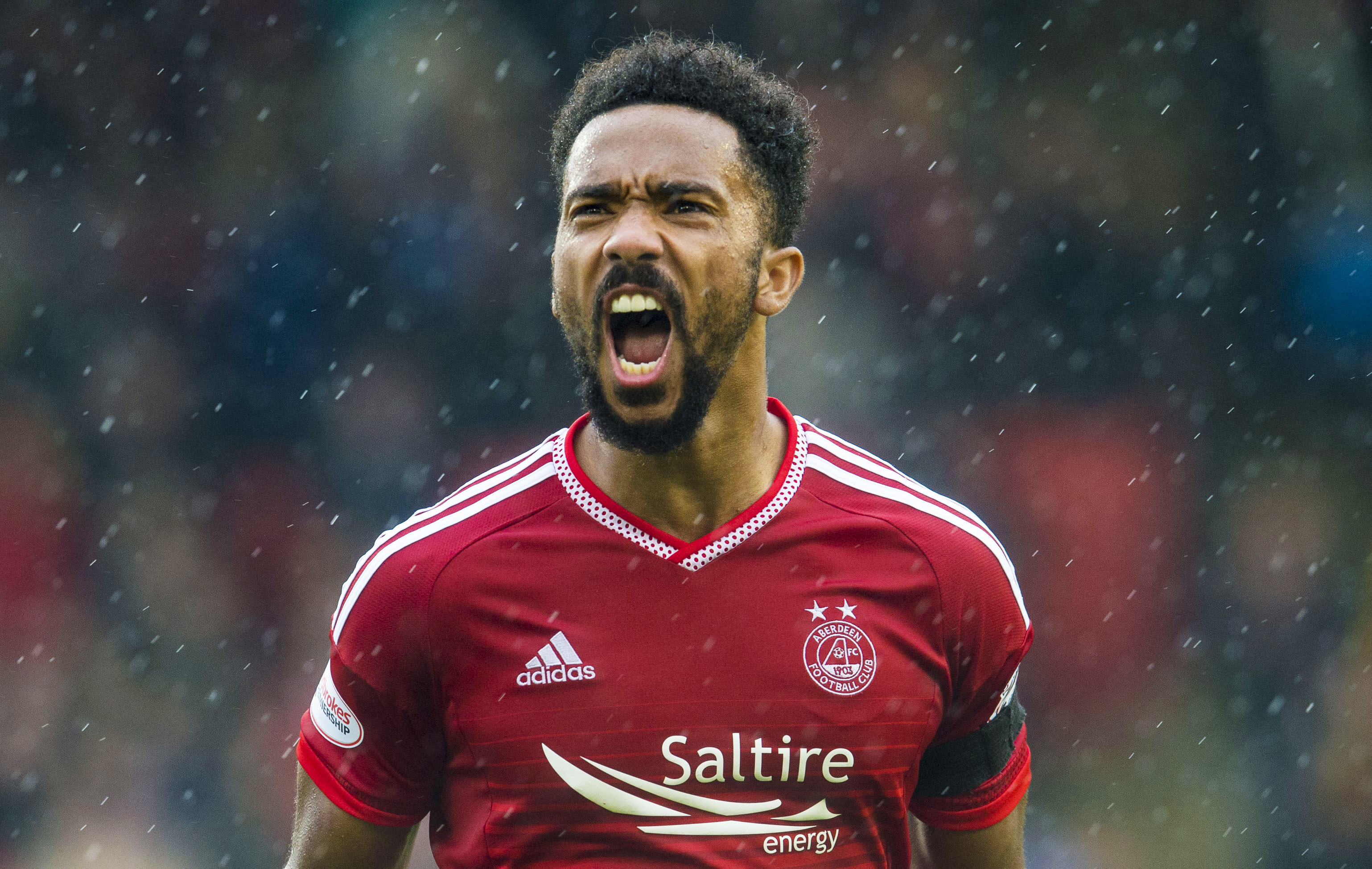 Dons defender Shay Logan has signed a new deal.