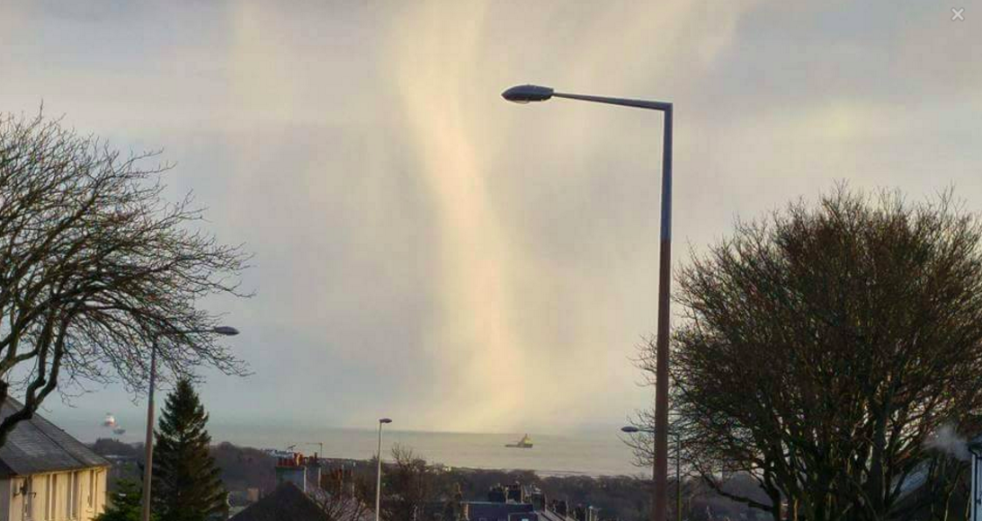 A snow shaft looms over a boat off the coast of Aberdeen. Picture by James Cheyne