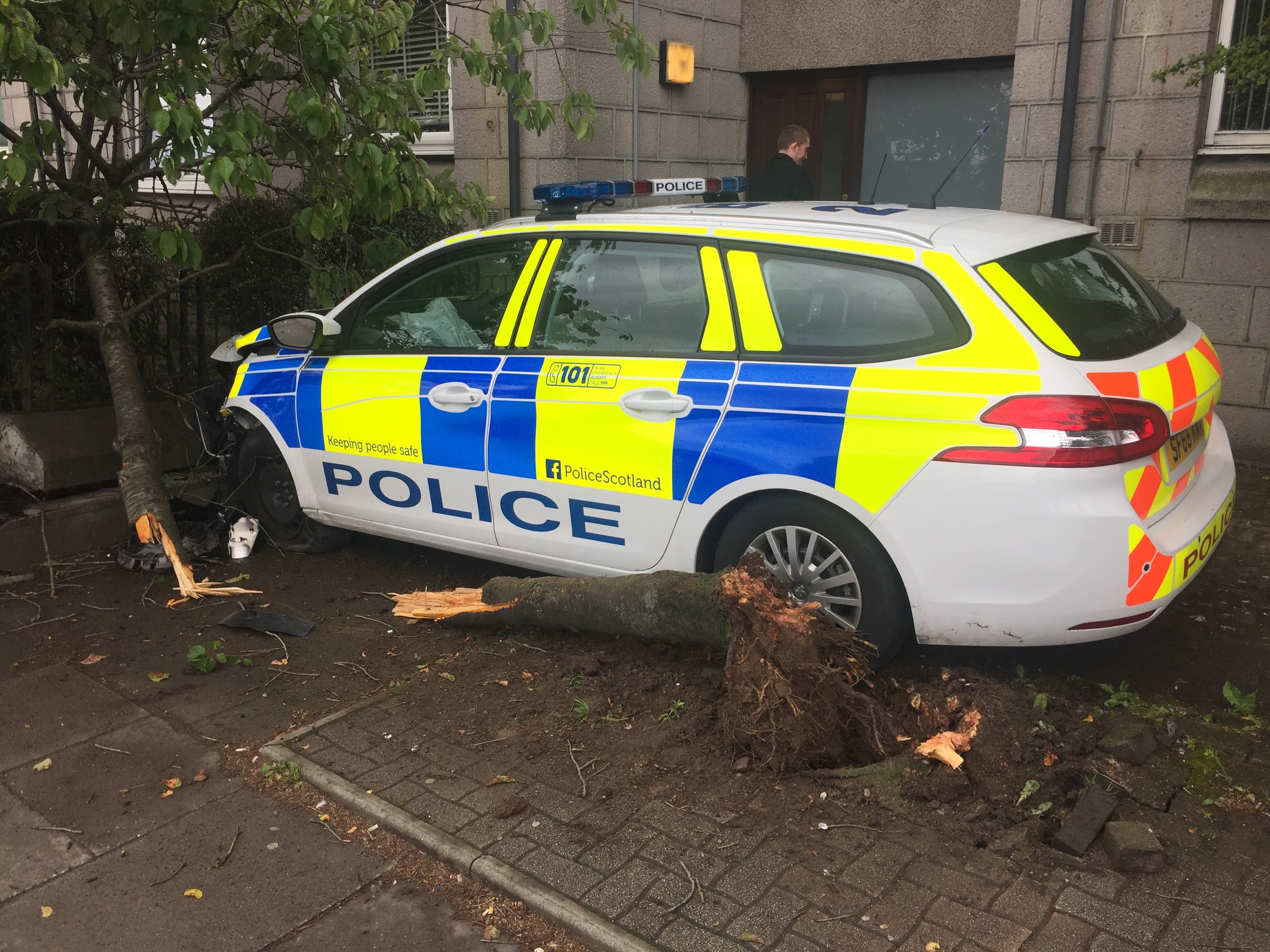 Video: Police car crashes through tree and into wall on Aberdeen street ...