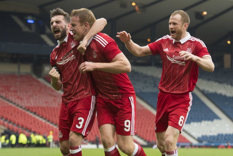 Mark Reynolds (right) celebrates with Graeme Shinnie and Adam Rooney at Hampden.
