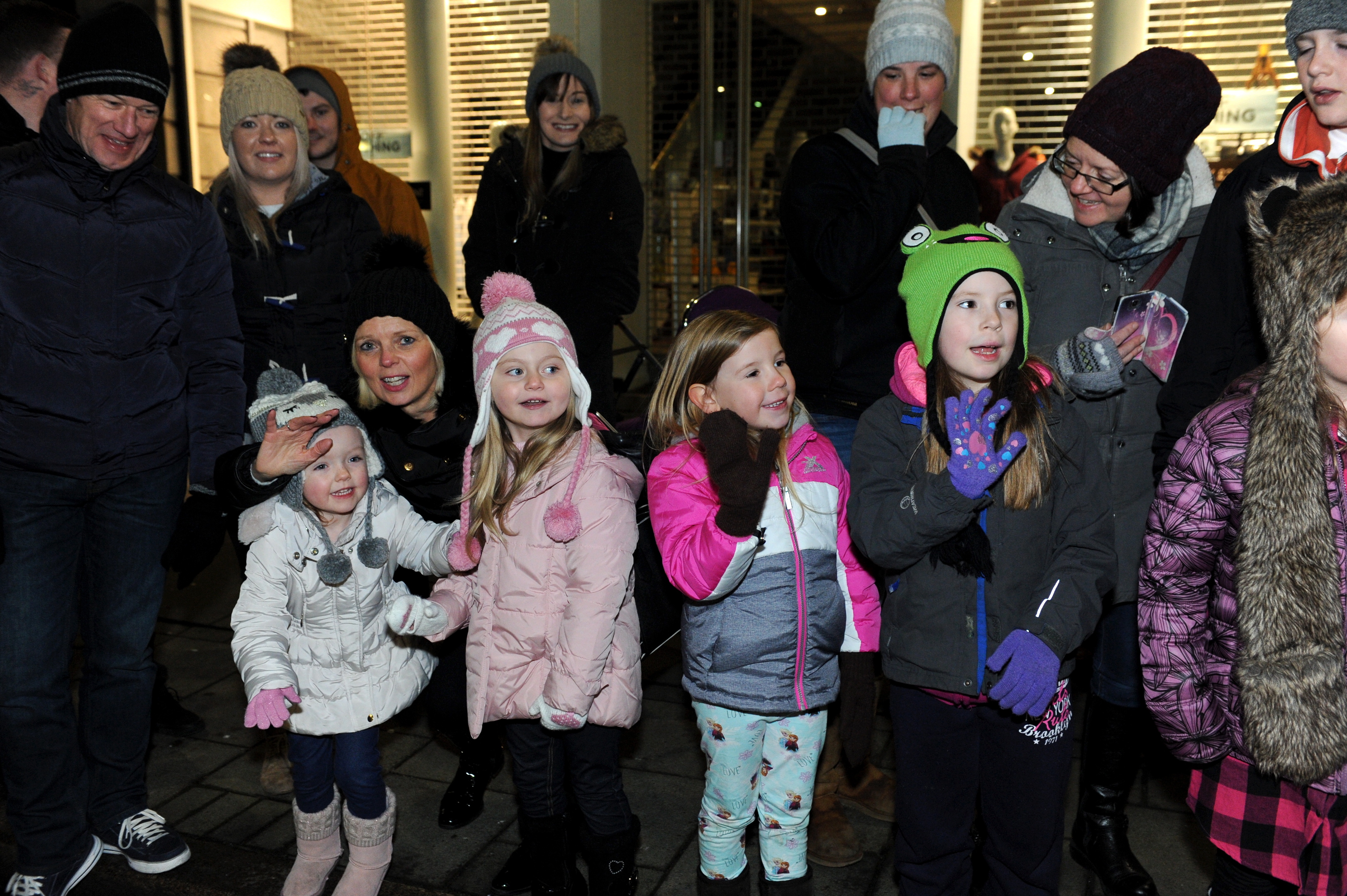 Waves: Delighted youngsters watch the colourful parade pass by on Union Street.