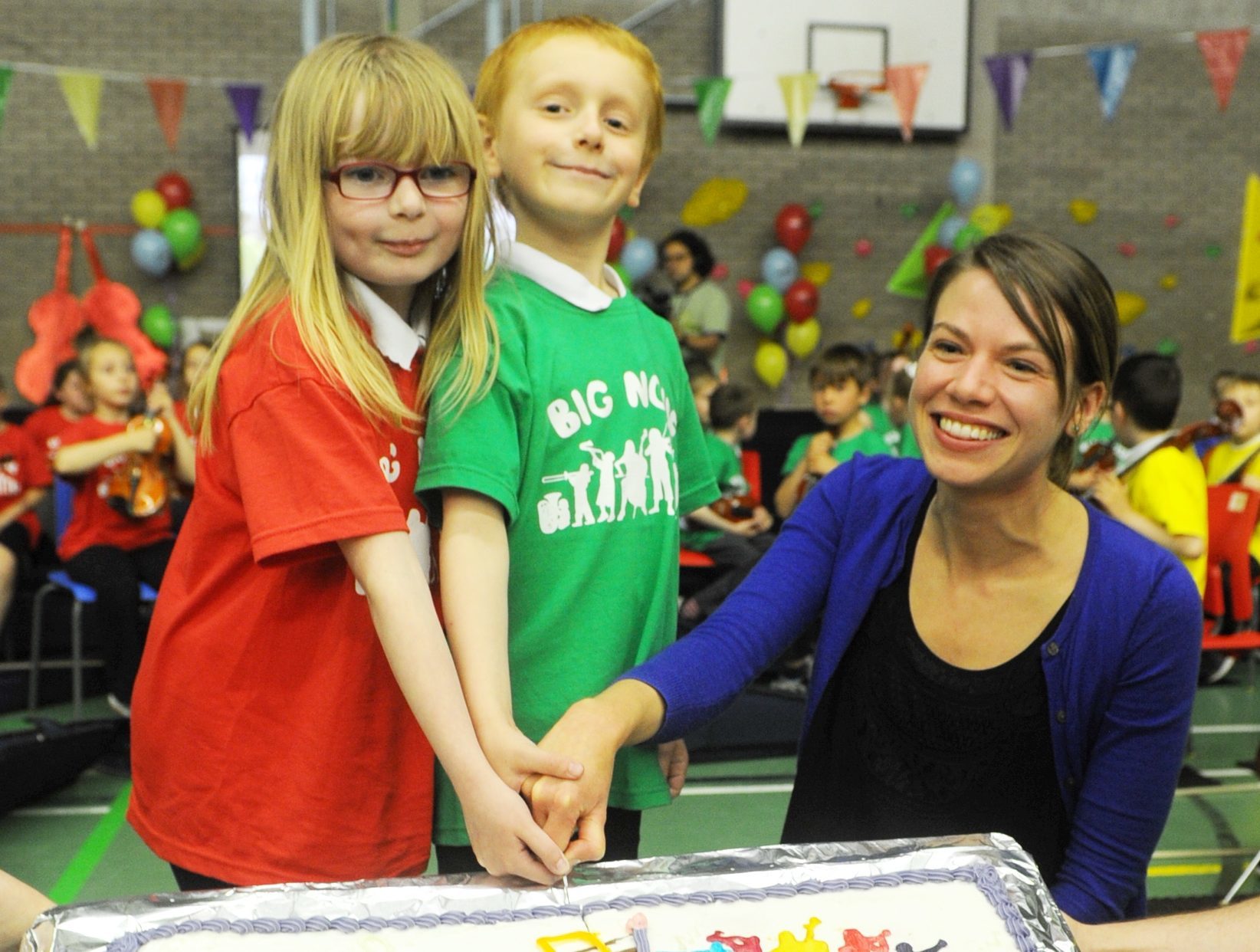 Aaliyah Thouless and Daniel Kondraciuk help Laura Horn of Big Noise Torry celebrate the group’s first year.
