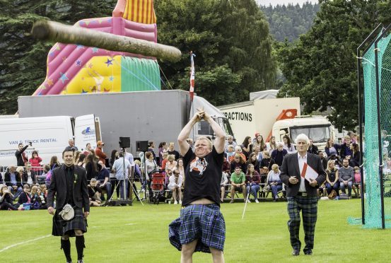 Tommy Fyvie from Aboyne tosses the caber