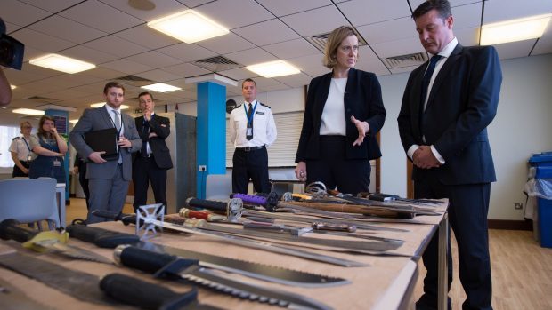 Home Secretary Amber Rudd is shown a collection of knives by Superintendent Sean Yates that have been involved in knife crime and recovered by the police in London
