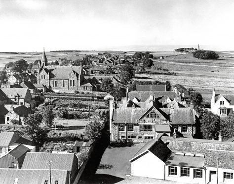 1962: Not an aerial view, but the next best thing. This is how New Deer looks from the top of St Kane's Church, looking across the village, with New Deer School in the foreground and the monument on the Hill of Culsh in the distance.