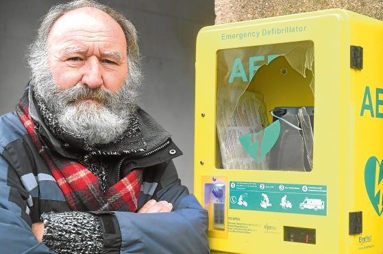 Pictured is Phil Mills-Bishop Chairman of Stonehaven Comunity Council pictured with the vandalised defibrillator box which is located in Stonehaven Market Square. Picture by Chris Sumner Taken 1/10/17