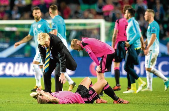 Scotland manager Gordon Strachan with Leigh Griffiths at full-time.