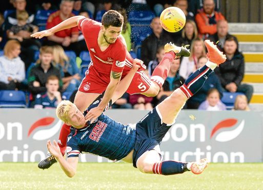 Aberdeen's Anthony O'Connor battles with Ross County's Thomas Mikkelsen.