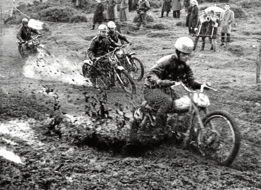 1962: The mud goes flying into the air during a motorcycle race at Newburgh.