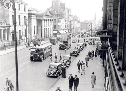 1958: Bikes, buses, cars and vans and even a horse and cart pass the Music Hall