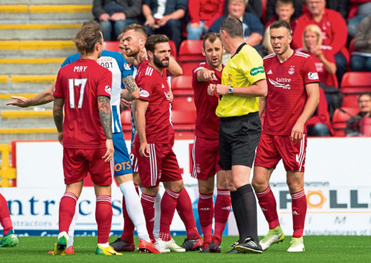 Aberdeen's Michael Devlin, left, is sent off by referee Craig Thomson.