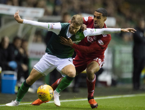 Hibernian's Martin Boyle (left) holds off Aberdeen's Max Love.