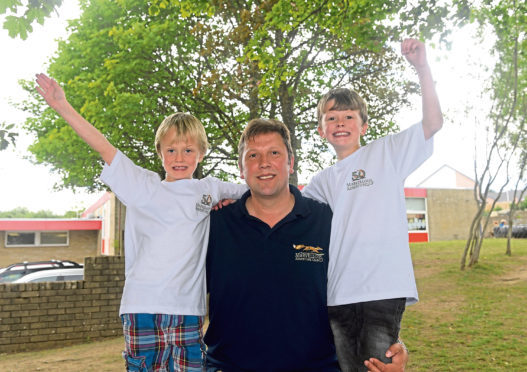From left, Harry, dad MacNeill Ferguson and brother Ollie