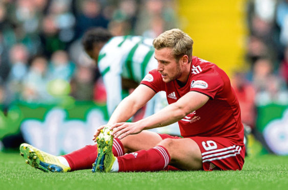 Aberdeen's James Wilson stretches out before being replaced at Parkhead a couple of weeks ago.