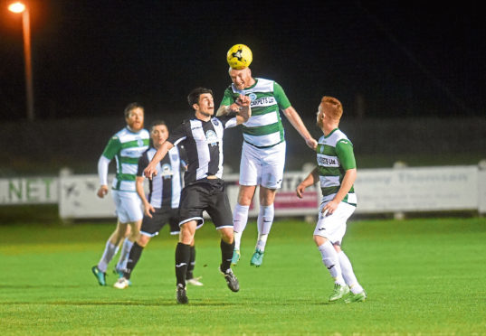 Buckie's Lewis MacKinnon and Fraserburgh's Willie West battle last term.
Picture by Heather Fowlie