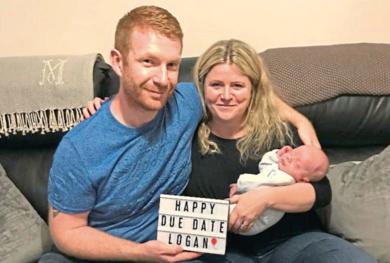 Logan Meek, who was born at the end of August, with mum Hazel and dad David