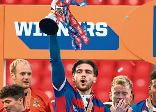 Inverness's George Oakley lifts the Irn-Bru Cup.