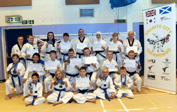 From left, top, assistant coach Aaron Reid; Ben Kaufmann, newly appointed black belt and silver medal for poomsae; assistant coach Shannon McNulty, silver medal in sparring; Conor Claire, newly appointed black belt; assistant coach Garry McNulty, achieved second dan black belt; Sawsan Basha, newly appointed black belt; Zoe Taylor, newly appointed black belt; Ally Reid, achieved second dan black belt
Middle, Louisa Smith, bronze medal for sparring and bronze medal for poomsae; Nathan Fong, achieved third Poom junior black belt; Ruadhan Claire, newly appointed black belt; Ethan Baxter, newly appointed black belt, silver medal for poomsae and silver for sparring; Lewis Campbell, newly appointed black belt and silver medal for poomsae; Saoirse McNulty, newly appointed black belt; Lucas Anderson, newly appointed black belt and bronze medal for poomsae
Bottom, Kayden Fong, silver medal for sparring; Anna-Mae Smith, bronze medal for poomsae and bronze medal for sparring; Seadna Claire, newly appointed black belt; Christina Stuart, bronze medal for poomsae; Ethan Thomson, bronze medal for sparring