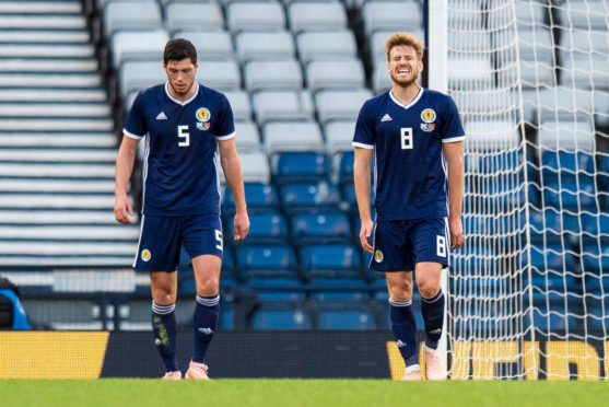 Scotland's Scott McKenna, left, and Stuart Armstrong are dejected after Portugal make it 1-0.