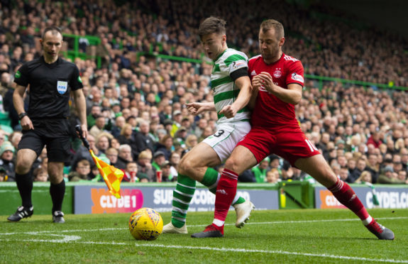 Celtic's Kieran Tierney (left) holds off Aberdeen's Niall McGinn