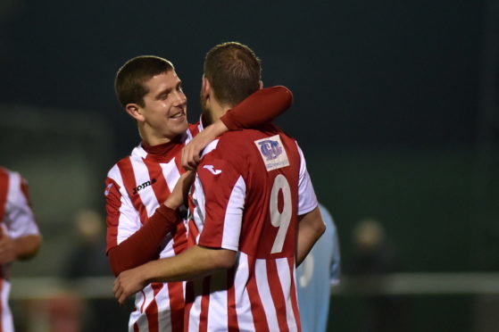 Formartine's Garry Wood (9) celebrates with team mate Jonathan Crawford after netting the opening goal against Deveronvale.
Picture by Scott Baxter