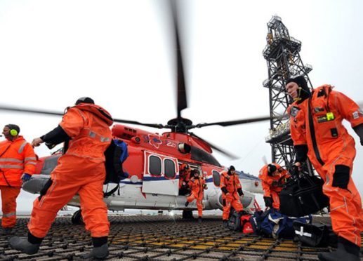 Offshore workers arrive on their platform by helicopter