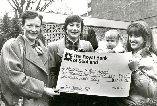 1987: Theresa Porter, Vanda Wilshire and Vanda’s daughter
Kimberley present BBC Scotland’s Jane Franchi, second left, with a cheque for £1,800