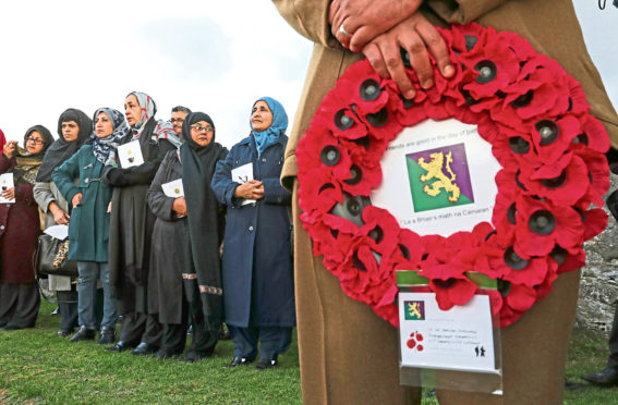 Women look on during Scotland's first multi-faith remembrance service for British Indian Army soldiers at Kingussie Cemetery in Badenoch. Andrew Milligan/PA Wire