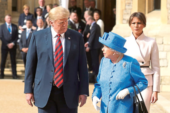 Queen Elizabeth II, US President Donald Trump and first lady Melania Trump walk in the Quadrangle during a ceremonial welcome at Windsor Castle, Windsor