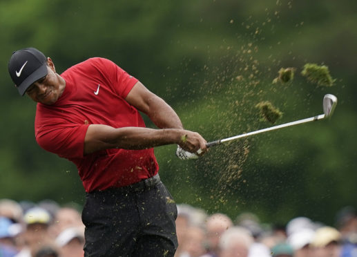Tiger Woods hits on the 12th hole during the final round for the Masters golf tournament, Sunday, April 14, 2019, in Augusta, Ga.