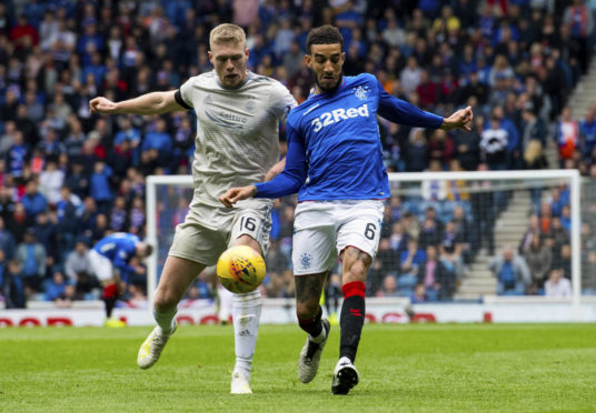 Aberdeen's Sam Cosgrove (left) in action with Rangers' Connor Goldson.