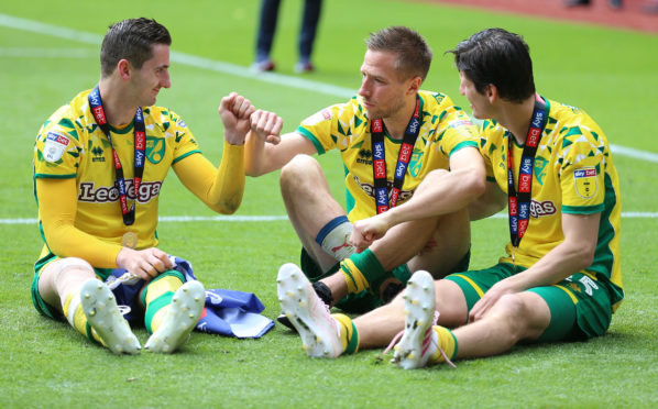 Norwich City's Kenny McLean, Marco Stiepermann and imm Klose celebrate after winning Sky Bet Championship match at Villa Park, Birmingham.