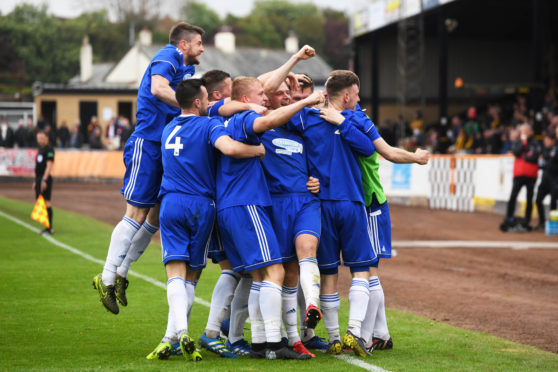 Cove's Jordan Brown celebrates his goal with his teammates