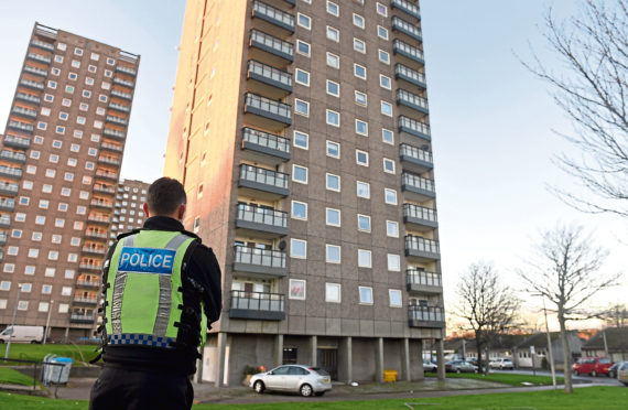 Police attend the incident at Donside Court where Aleksander Smerdel was found dead