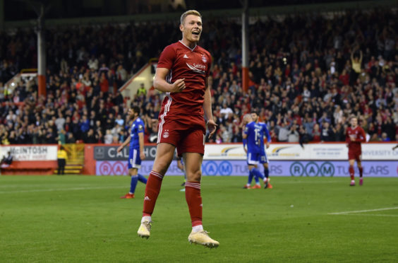Sam Cosgrove celebrates his third goal and Aberdeen's fifth
