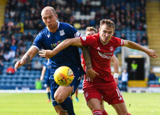 Aberdeen's Ryan Hedges (right) holds off Jordon Forster