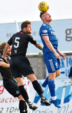 Rory McAllister, right, winning a header