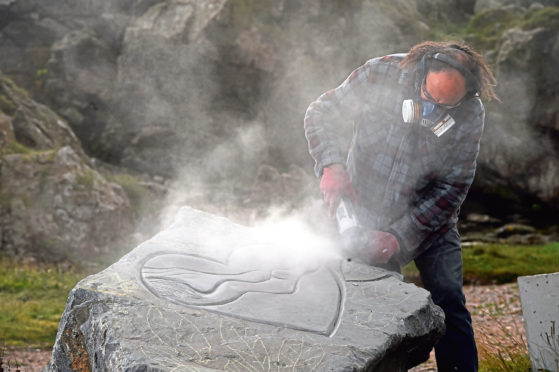 Sculptor Albertino Costa at work.